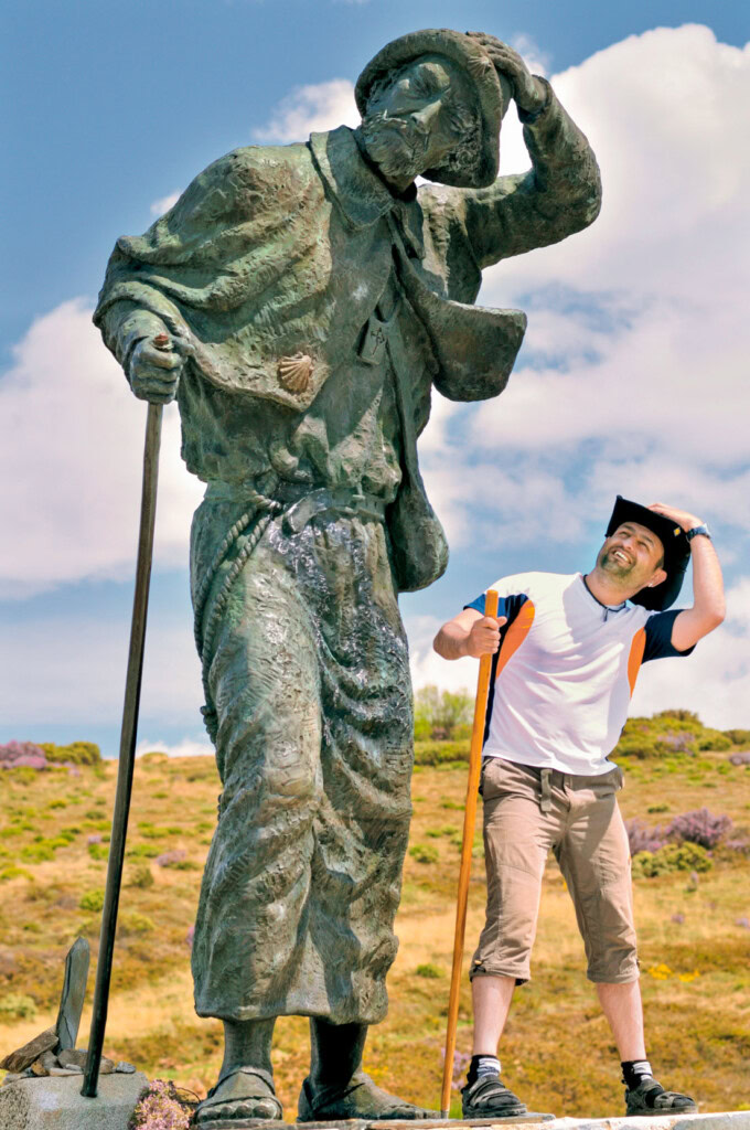 A tourist posing next to a monument in Spain.