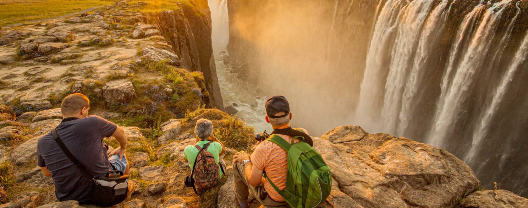Tourists enjoying the sunset over Victoria Falls, Zimbabwe.