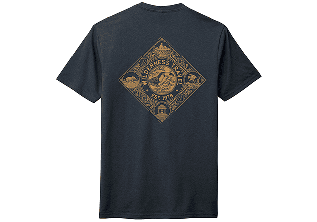 Dark T-shirt featuring the "Wilderness Patrol" logo on the back, showcasing a bear, eagle, and trees in a diamond shape. Established 1976. Perfect for WT Toucan Club members or as gifts with exclusive discounts available.